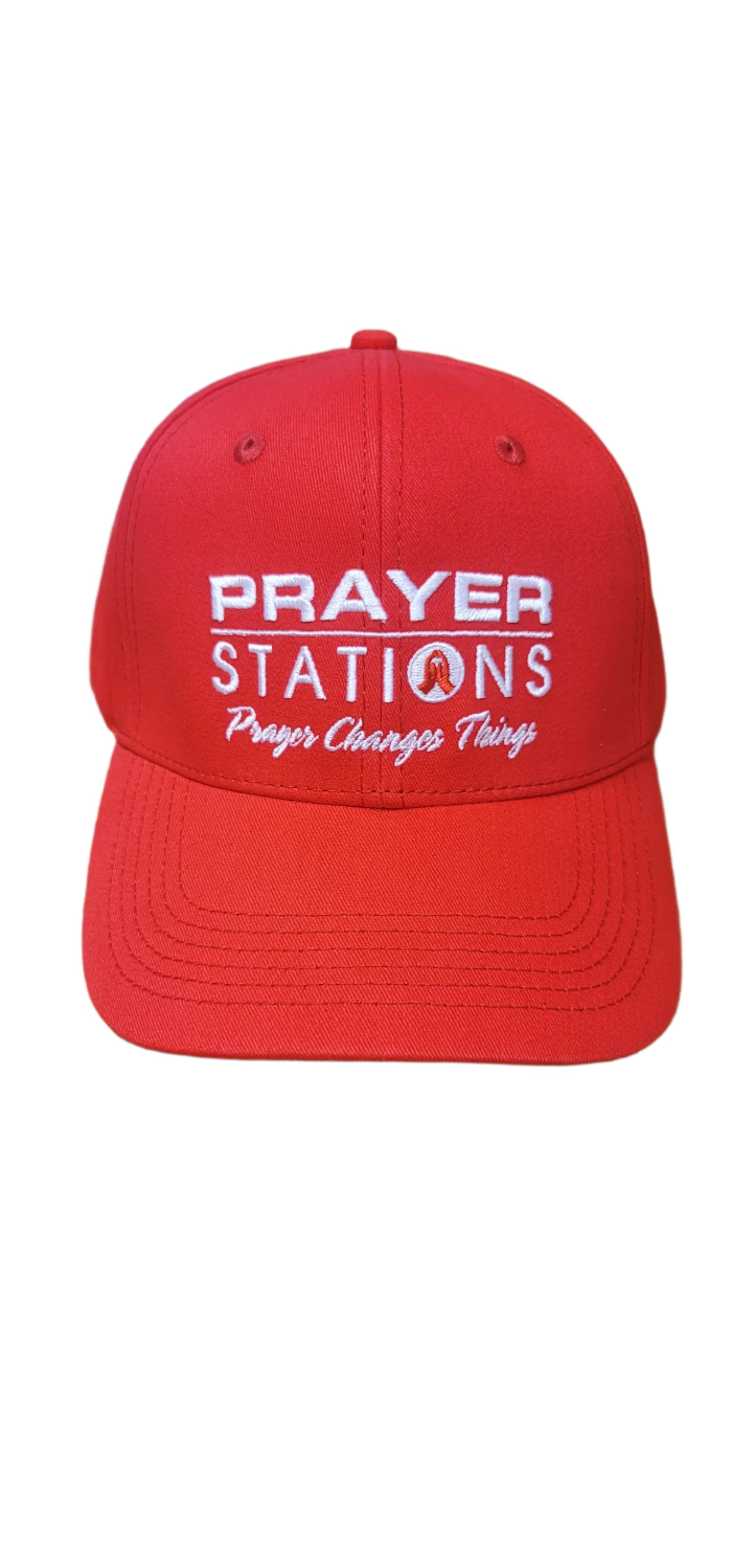 Red cap with 'Prayer Stations' text on a textured surface